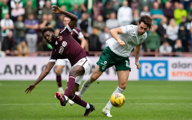 Beni Baningime and Joe Newell challenge for the ball in the Edinburgh derby