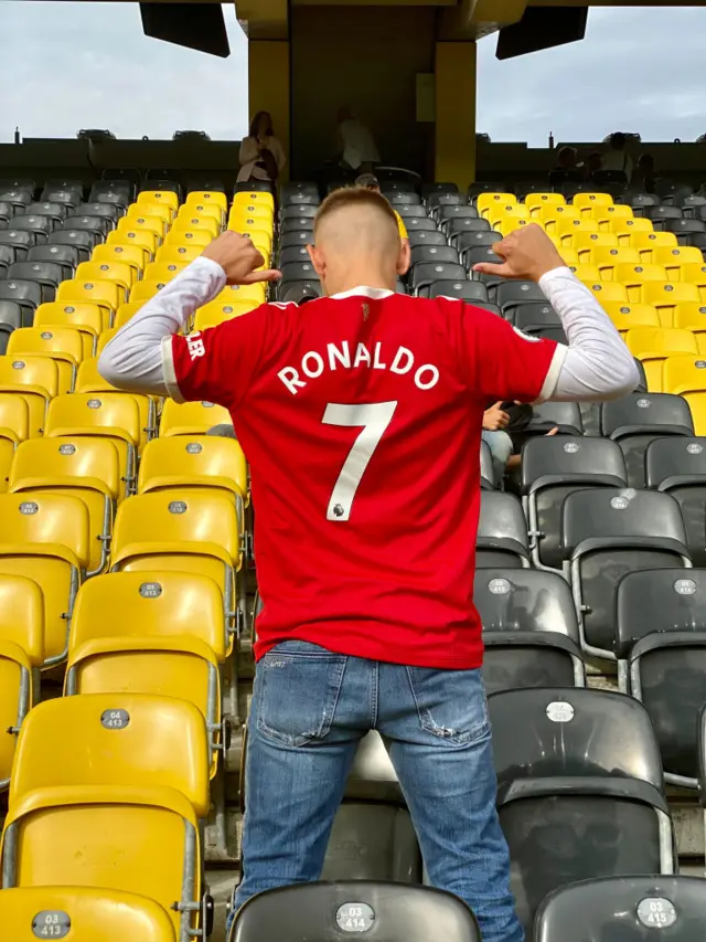 A Manchester United fan shows off this season's Cristiano Ronaldo replica shirt