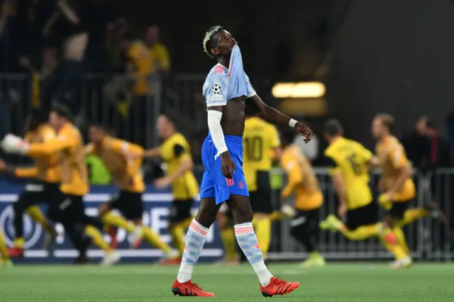 Paul Pogba looks dejected as Young Boys celebrate the winner