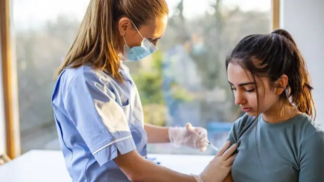 Young person having a vaccine