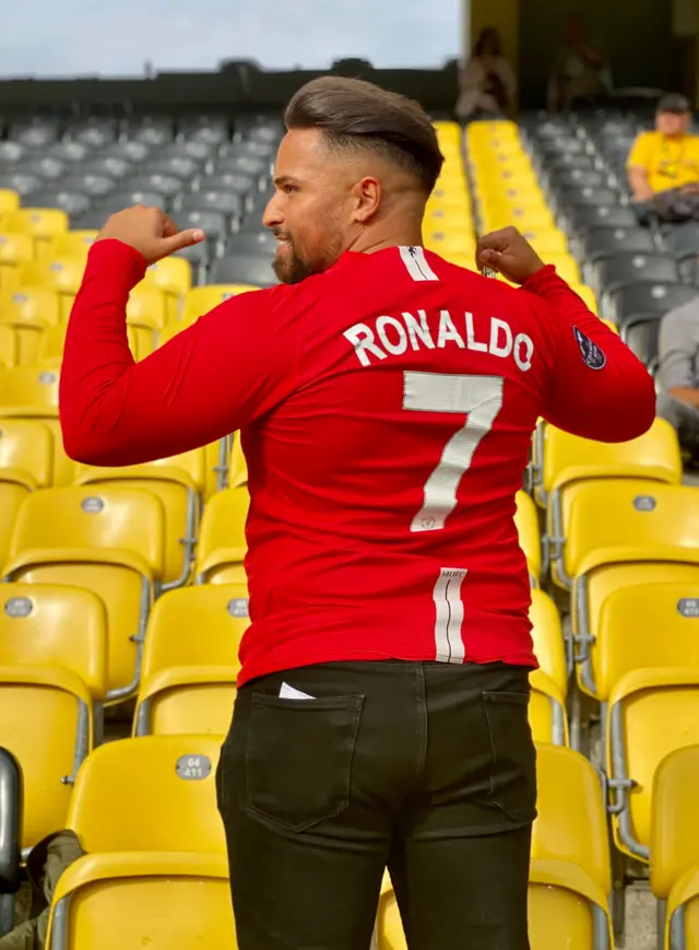 A Manchester United fan shows of a replica Cristiano Ronaldo shirt