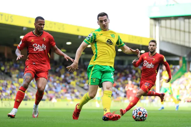 Kenny McLean of Norwich City is challenged by William Troost-Ekong of Watford