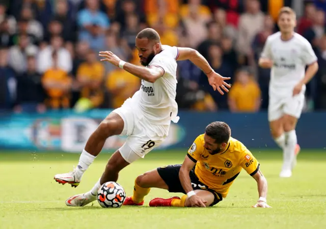 Brentford's Bryan Mbeumo (left) and Wolverhampton Wanderers' Joao Moutinho battle for the ball