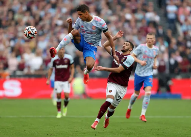 Raphael Varane of Manchester United battles for possession with Said Benrahma of West Ham United