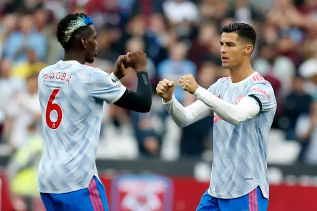 Manchester United's French midfielder Paul Pogba (L) and Manchester United's Portuguese striker Cristiano Ronaldo