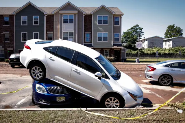 Flood damaged cars are seen at the Oakwood Plaza Apartments in New Jersey