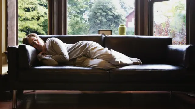 Woman lying on sofa