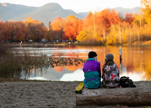 A couple enjoy the view at a lake in Vancouver