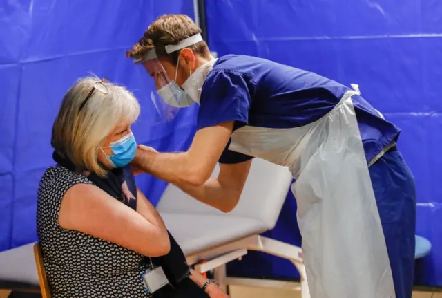 A woman receives a Covid-19 vaccine at the vaccination centre at the Bournemouth International Centre