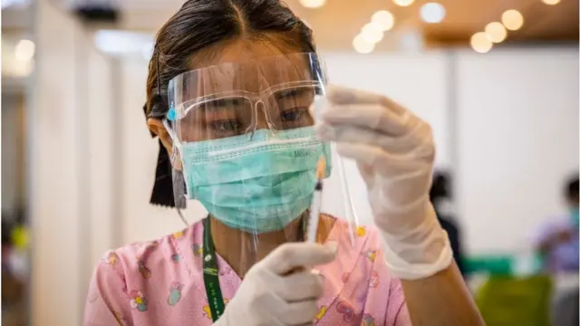 Health worker prepares vaccine