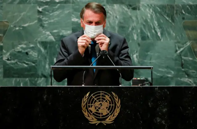 Brazil's President Jair Bolsonaro puts his face mask back on after speaking at the 76th Session of the UN General Assembly in New York on 21 September 2021