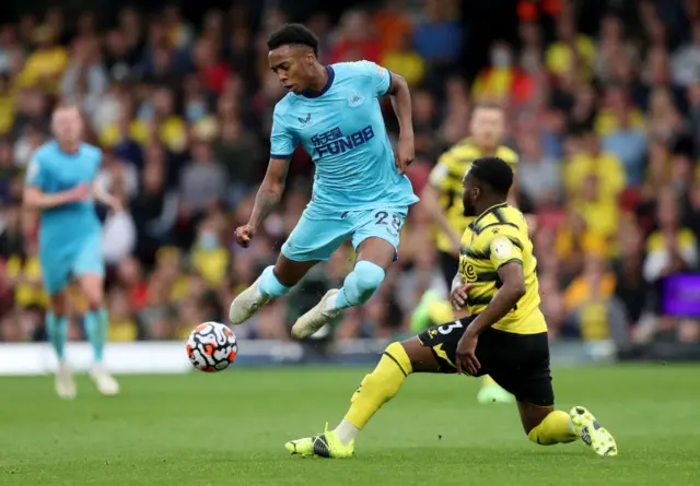 Joe Willock challenged on the ball against Watford