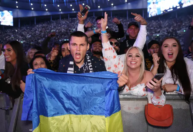 A fan holds a Ukraine flag at the Anthony Joshua fight