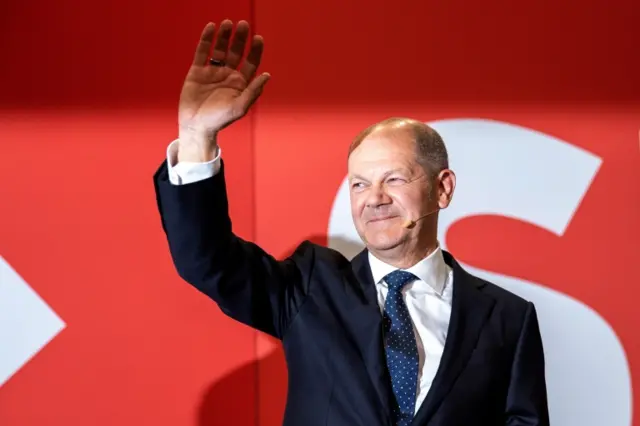 Olaf Scholz, chancellor candidate of the German Social Democrats (SPD), waves to supporters in reaction to initial results at SPD headquarter during the Social Democratic Party (SPD) election event in Berlin, Germany, 26 September 2021