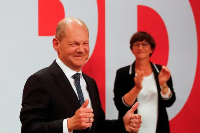 Olaf Scholz and party co-leader Saskia Esken react after first exit polls for the general elections in Berlin, Germany, September 26, 2021.