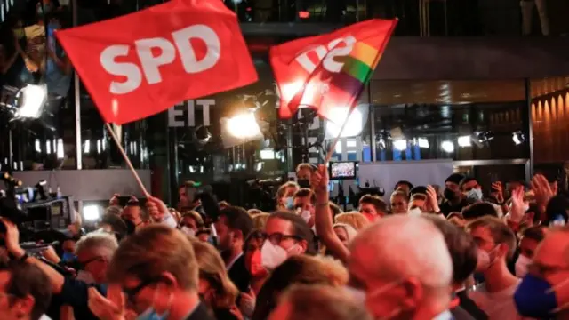 Social Democratic Party (SPD) supporters react after first exit polls