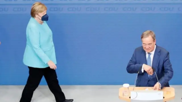 Angela Merkel and Christian Democrats (CDU/CSU) candidate Armin Laschet arrive on stage