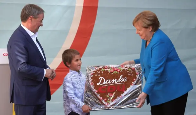 Angela Merkel accepts a thank-you cake