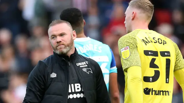 Wayne Rooney looks on