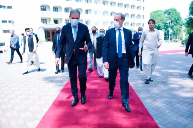 Pakistan's Foreign Minister Shah Mahmood Qureshi (L) welcomes UK Foreign Secretary Dominic Raab upon his arrival at the Ministry of Foreign Affairs in Islamabad, Pakistan