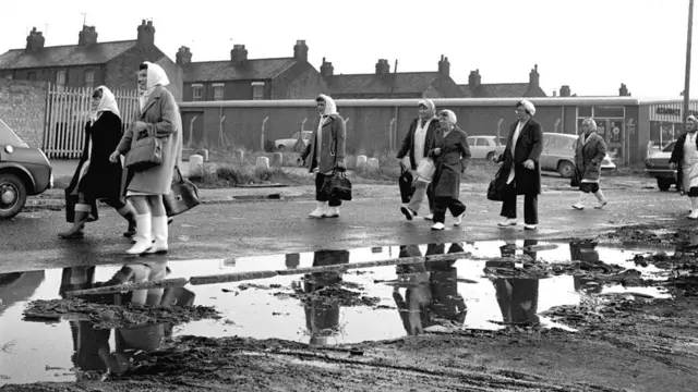 Women walk to work along Hessle Road