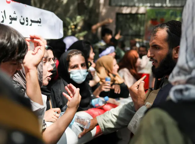 Women argue with a Taliban fighter during a protest for women's rights in Kabul on Tuesday.