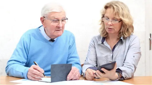 Two pensioners working out their pensions