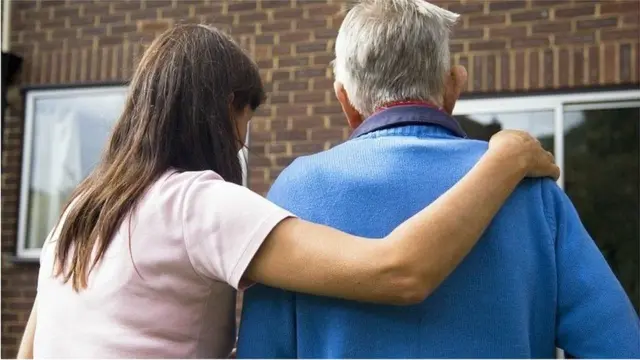 A carer helps an older person