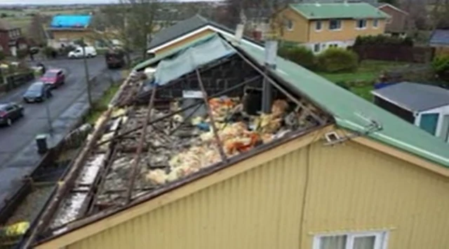 The house of Sheila and Bob Johnson, with half the roof missing