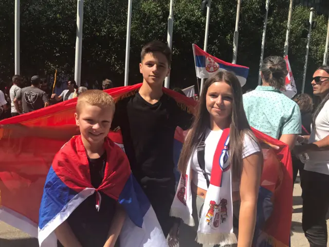 The Grmusa children give their support to Djokovic outside court