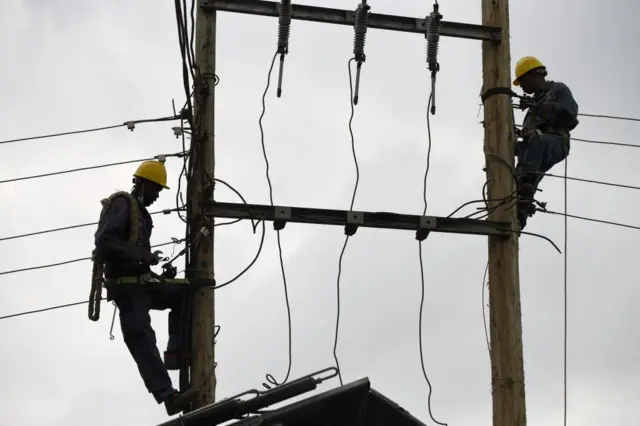 Workers at a Kenya power company site