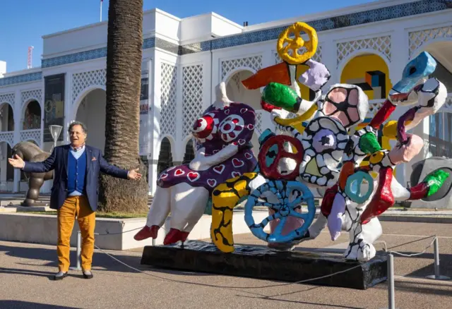 Mehdi Qotbi, the president of the National Museum Foundation (FNM) presents "The Dream Machine", a sculpture by the late Franco-American artist Niki de Saint Phalle outside the Mohammed VI Museum of Modern and Contemporary Art (MMVI), in Morocco's capital Rabat on 12 January 2022