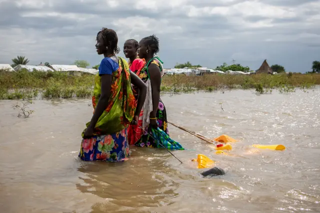 Women in Pibor collecting water in floods