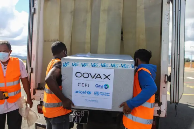 Airport workers in Madagascar unload boxes of Covid-19 vaccines sent by Covax.