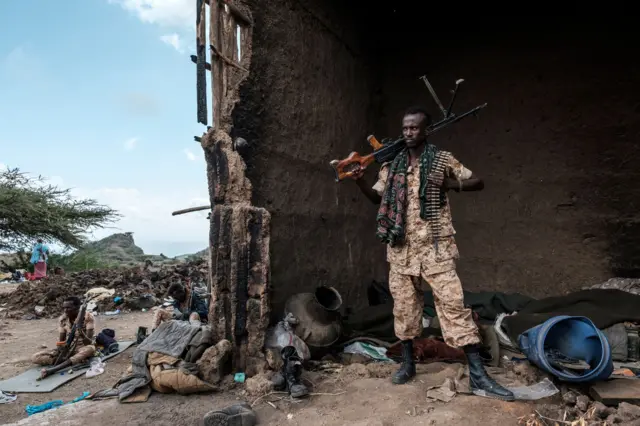 A member of the Afar Special Forces stands with a machine gun in a damaged house in the outskirts of the village of Bisober, Tigray Region, Ethiopia, on December 09, 2020