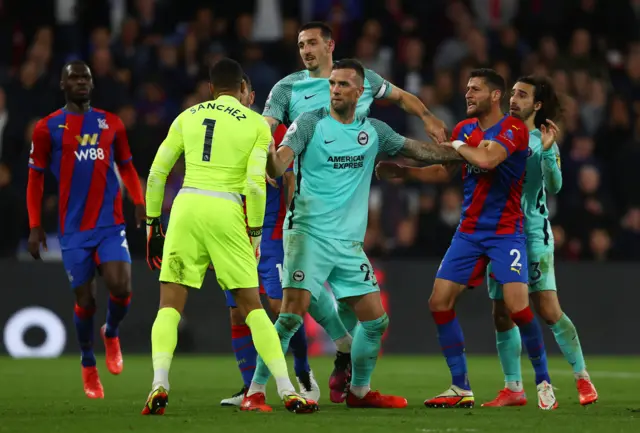 Shane Duffy of Brighton separates Robert Sanchez and Joel Ward of Crystal Palace