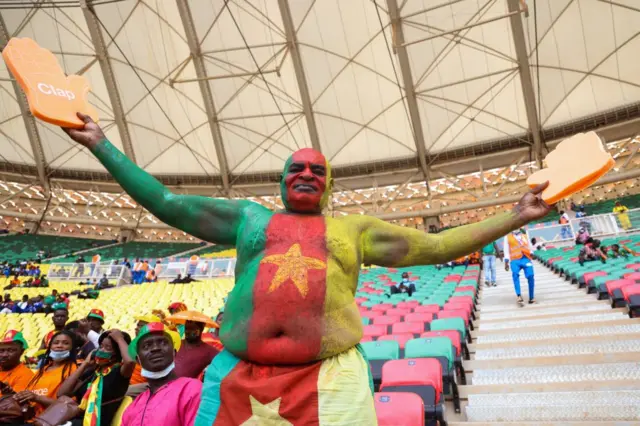 Cameroon football supporter cheers in the stands ahead of the Group A Africa Cup of Nations (CAN) 2021 football match between Cameroon and Ethiopia at Stade d'Olembé in Yaoundé.