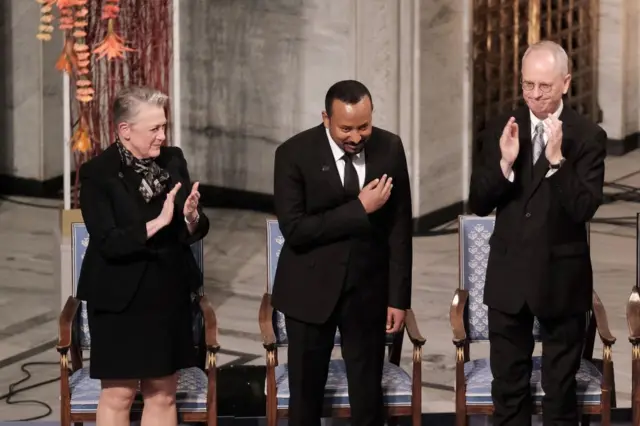 Chairman of the Norwegian Nobel Committee Berit Reiss-Andersen, Ethiopia's Prime Minister and 2019 Nobel Peace Prize Laureate Abiy Ahmed Ali and member of the Norwegian Nobel Peace Prize comittee Henrik Syse are seen on stage during the Nobel Peace Prize ceremony 2019 at Oslo City Town Hall on 10 December 2019 in Oslo, Norway.