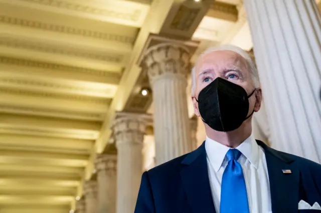 President Joe Biden speaks to reporters in the Hall of Columns