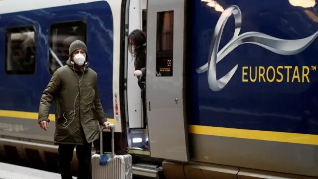 Passenger walking past a Eurostar train in Paris