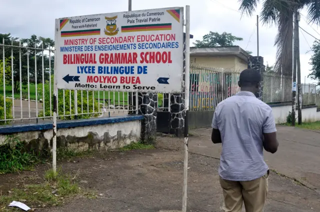 A man walks past the entrance of the bilingual school in Buea, capital of south west Cameroon,