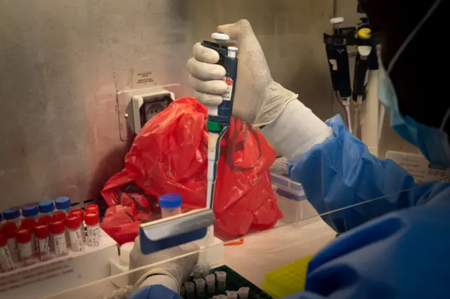 A laboratory technician processes samples for testing the Covid-19 virus in Rwanda