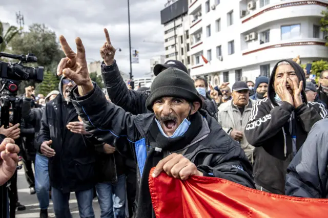 Tunisians take part in a demonstration against President Kais Saied, on the 11th anniversary of the Tunisian revolution in the capital Tunis on January 14, 2022