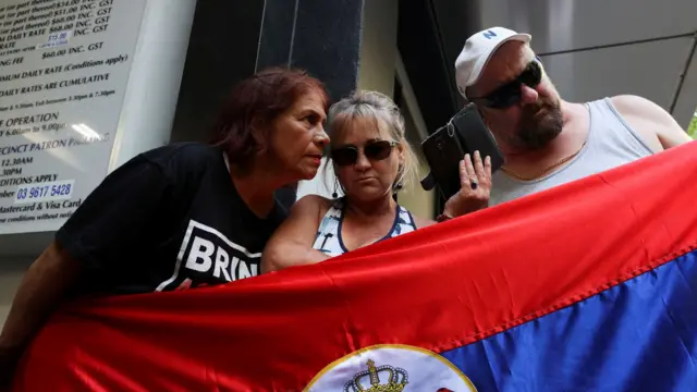 Supporters listen to court on phone