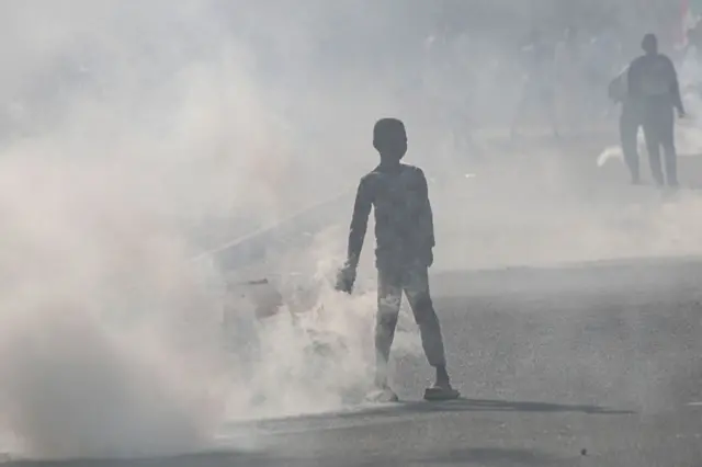 Tear gas fills the air at a protest in Khartoum, Sudan, on 13 January.