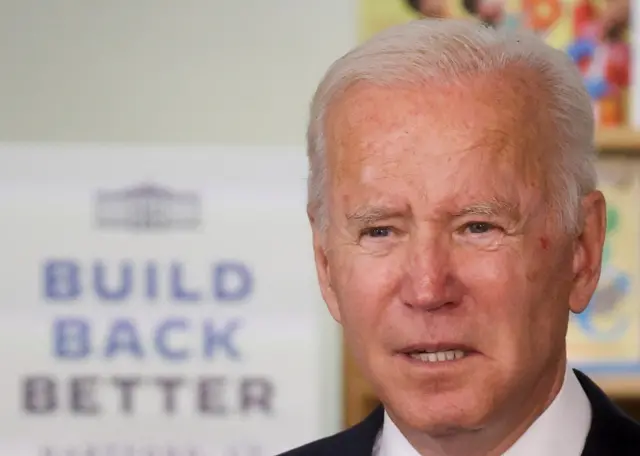 Close-up of Joe Biden in front of a 'Build Back Better' sign