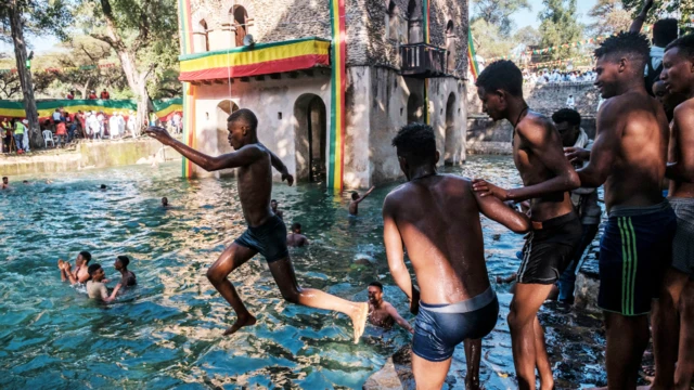 Ethiopian Orthodox worshippers at the compound of Fasilides Bath during the celebration of Timket, the Ethiopian Epiphany, in the city of Gondar, Ethiopia – 19 January 2022