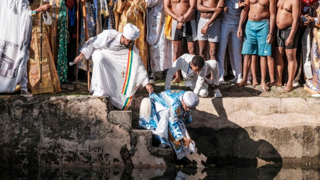 Ethiopian Orthodox worshippers at the compound of Fasilides Bath during the celebration of Timket, the Ethiopian Epiphany, in the city of Gondar, Ethiopia – 19 January 2022