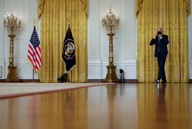 U.S. President Joe Biden answers arrives for a news conference in the East Room of the White House on January 19