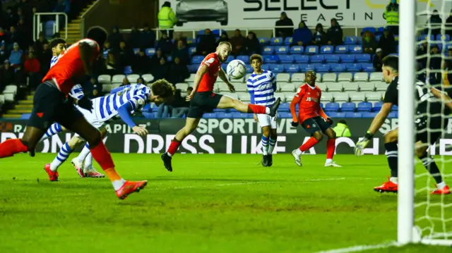 Tom Holmes heads into his own net